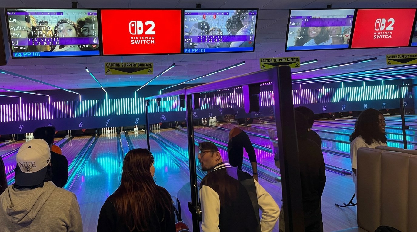 Nintendo Switch 2 creative on overhead scoreboard screens above the lanes