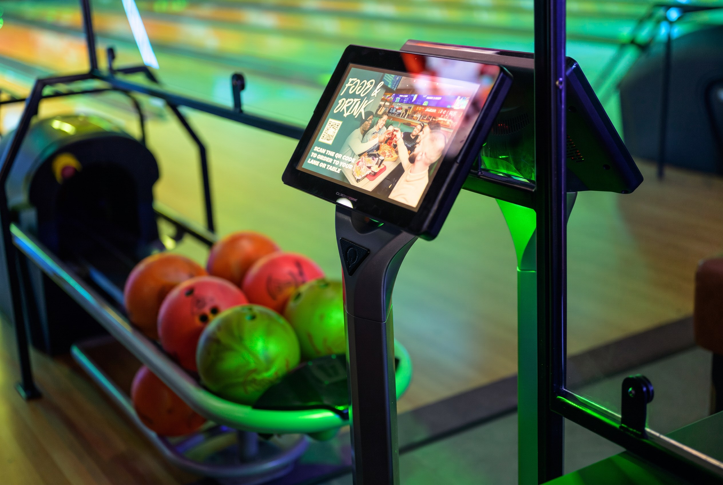 Lane-side ordering kiosk showing food and drink ads