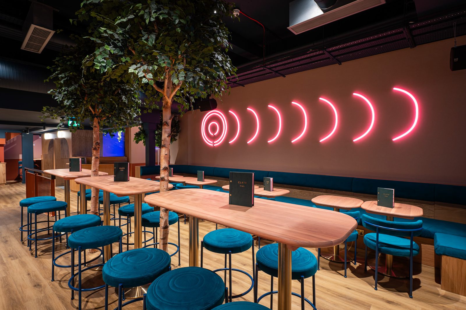 Clays lounge with neon target wall and premium seating